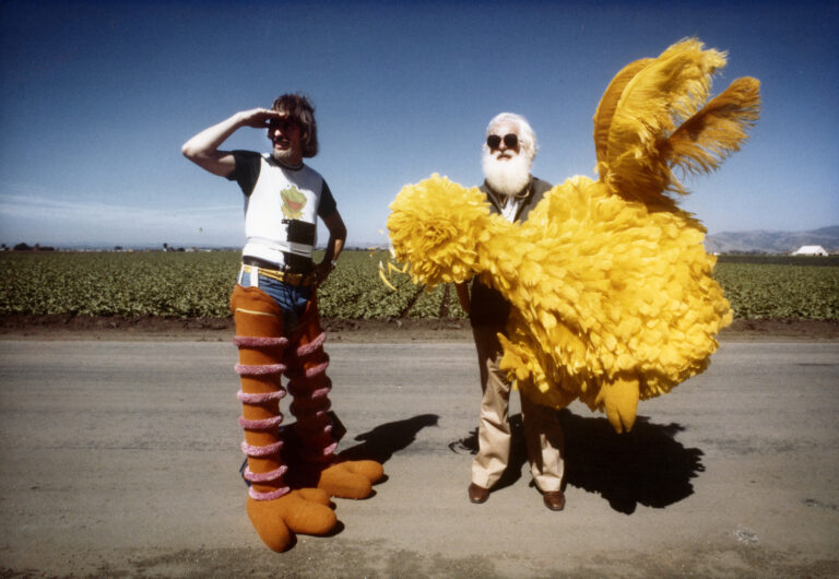Caroll Spinney and friend in Big Bird costume on a road, promoting "I Am Big Bird"