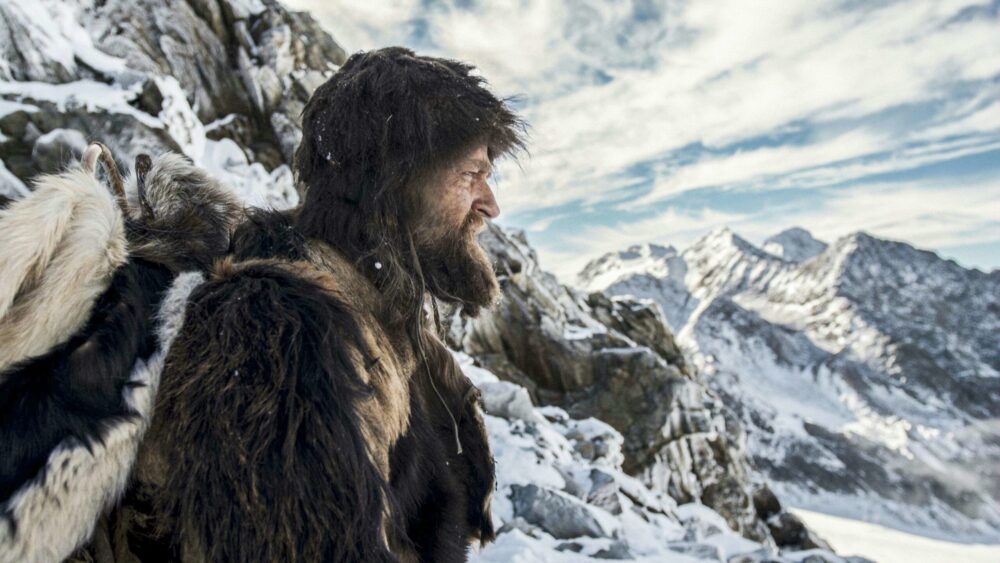 Iceman Ötzi in fur clothing on a snowy mountain