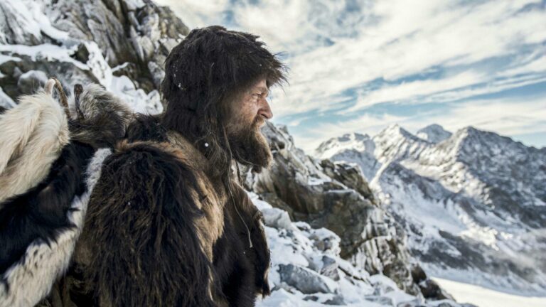 Iceman Ötzi in fur clothing on a snowy mountain
