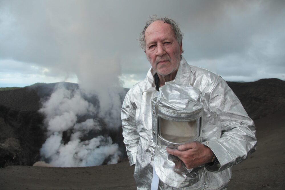 Werner Herzog in a silver protective suit at a volcano.