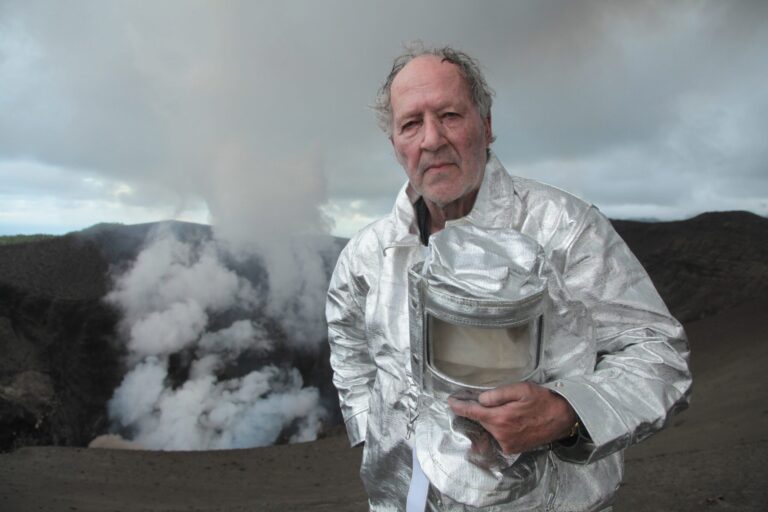 Werner Herzog in a silver protective suit at a volcano.