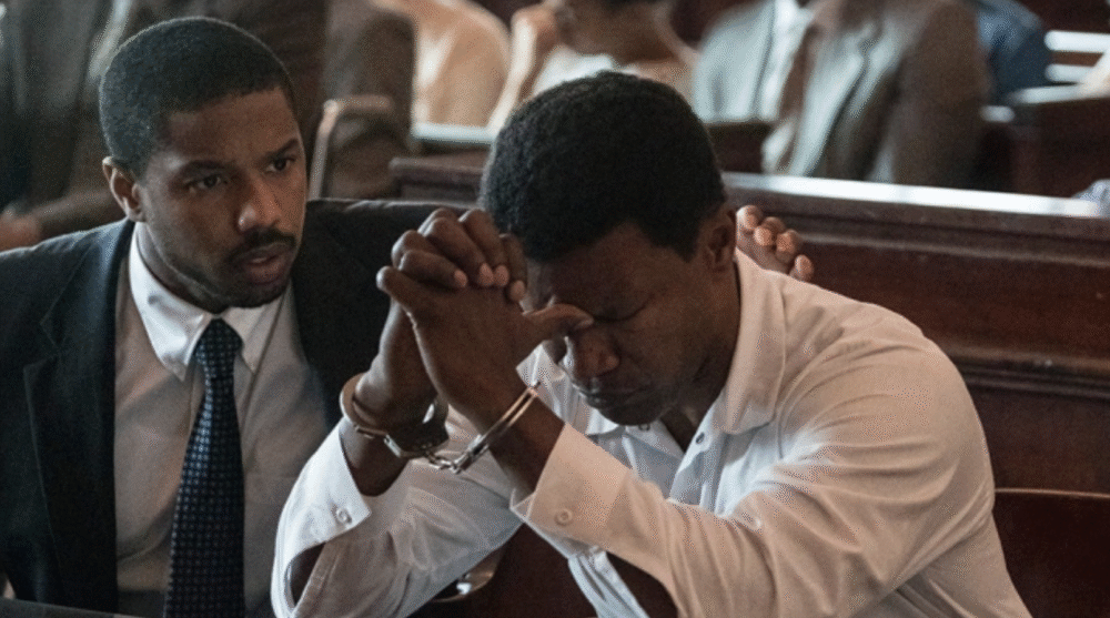 Michael B. Jordan comforts a handcuffed man in "Just Mercy", courtroom scene.