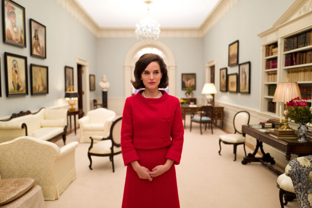 Natalie Portman as Jackie Kennedy in "Jackie," standing in the White House.