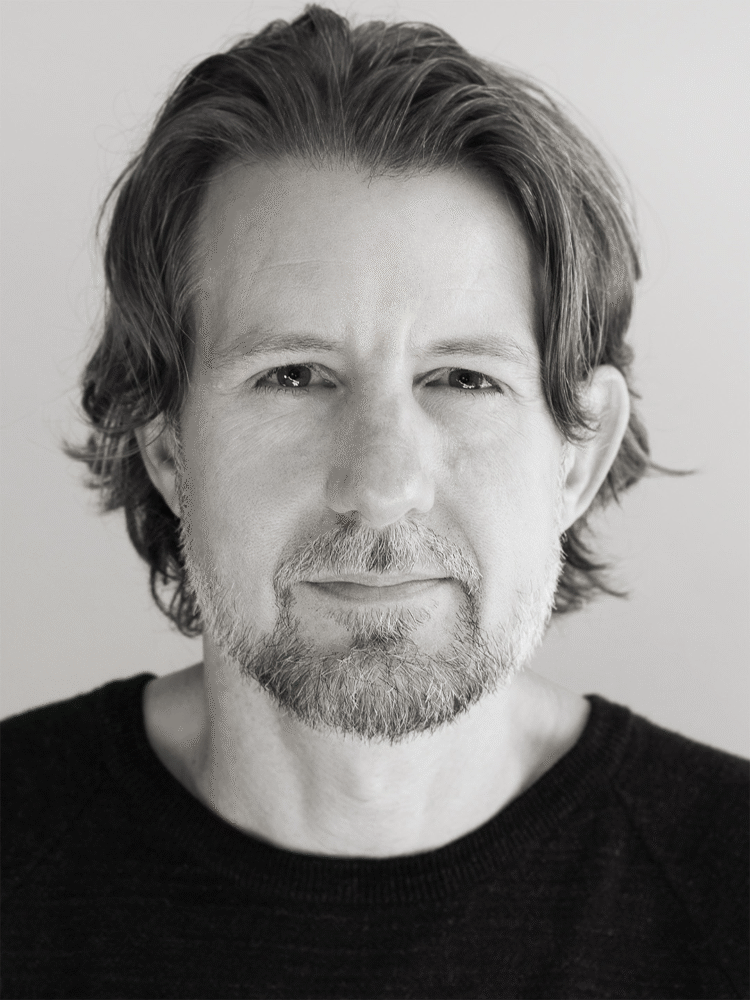 Black and white portrait of James Rowe with a beard