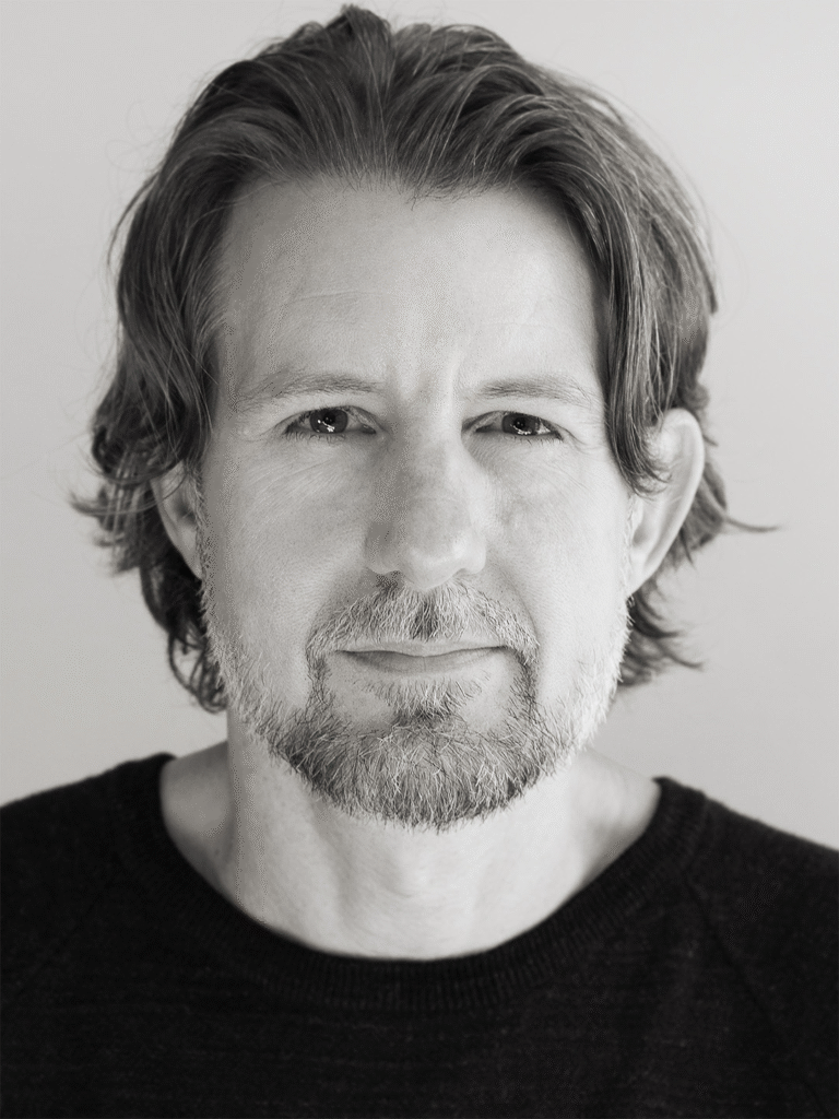 Black and white portrait of James Rowe with a beard