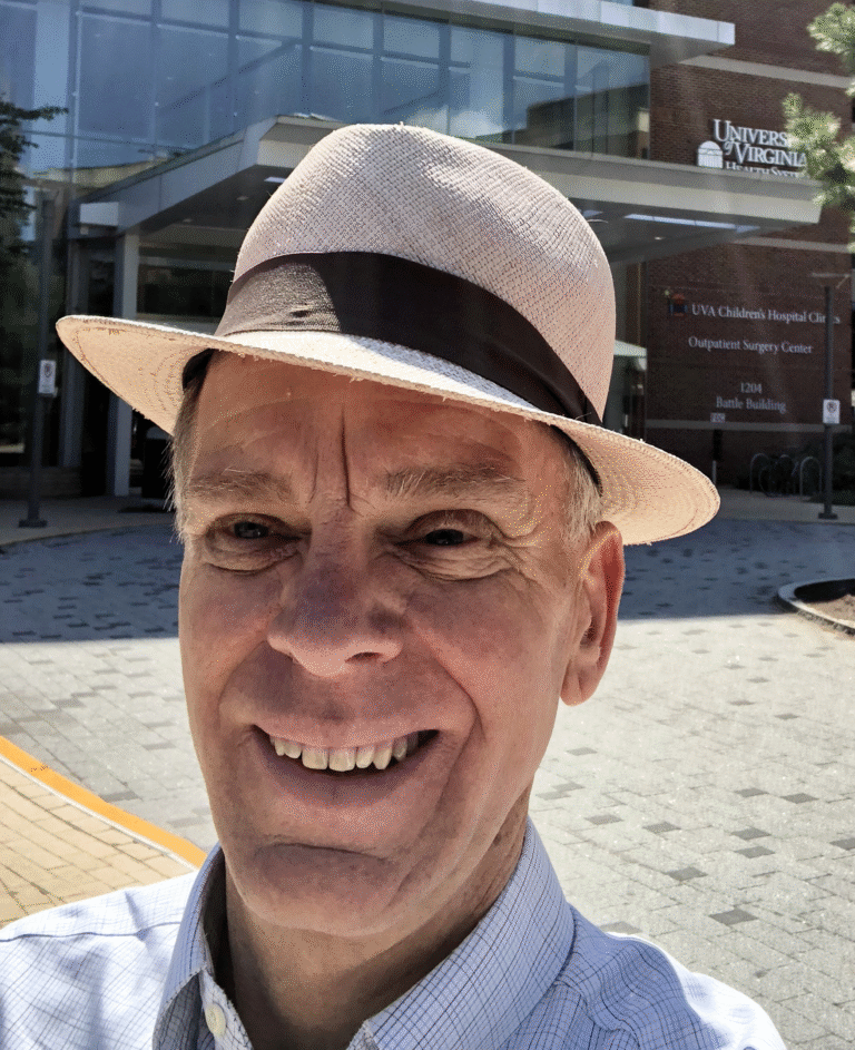 Jim Plews-Ogan smiles in front of the UVA Children's Hospital Outpatient Surgery Center.