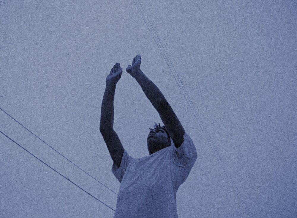 Man with arms raised toward the sky.