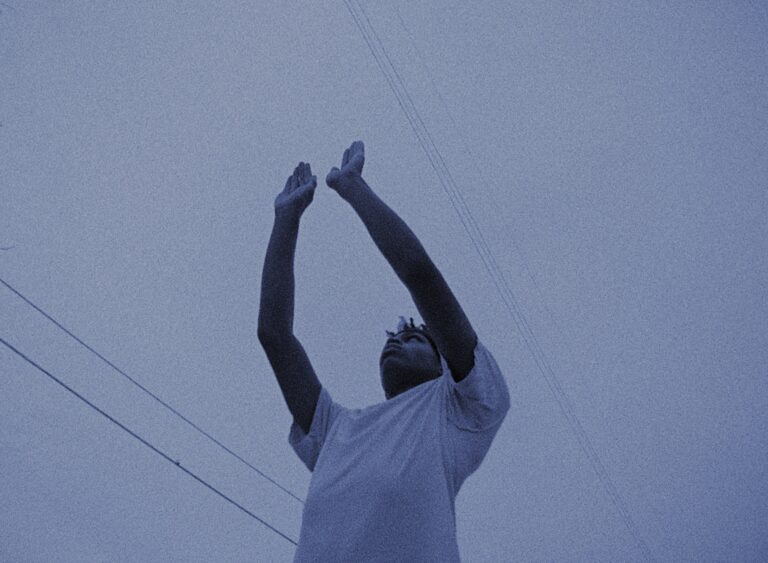 Man with arms raised toward the sky.