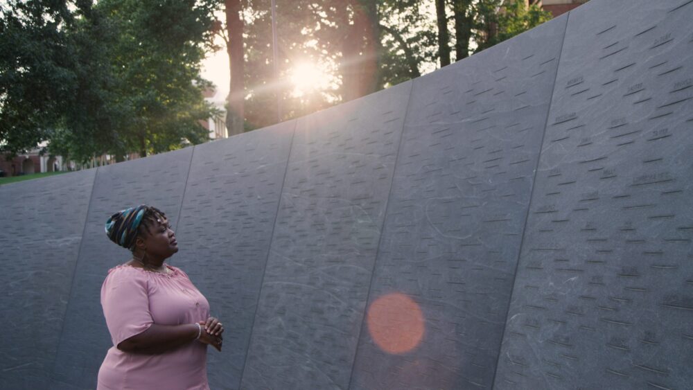 Woman at memorial wall.