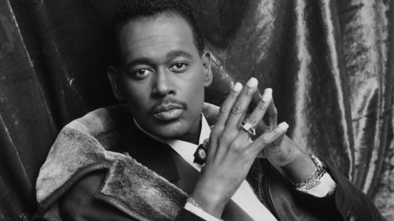 Luther Vandross portrait in a suit, wearing a ring and bracelet.