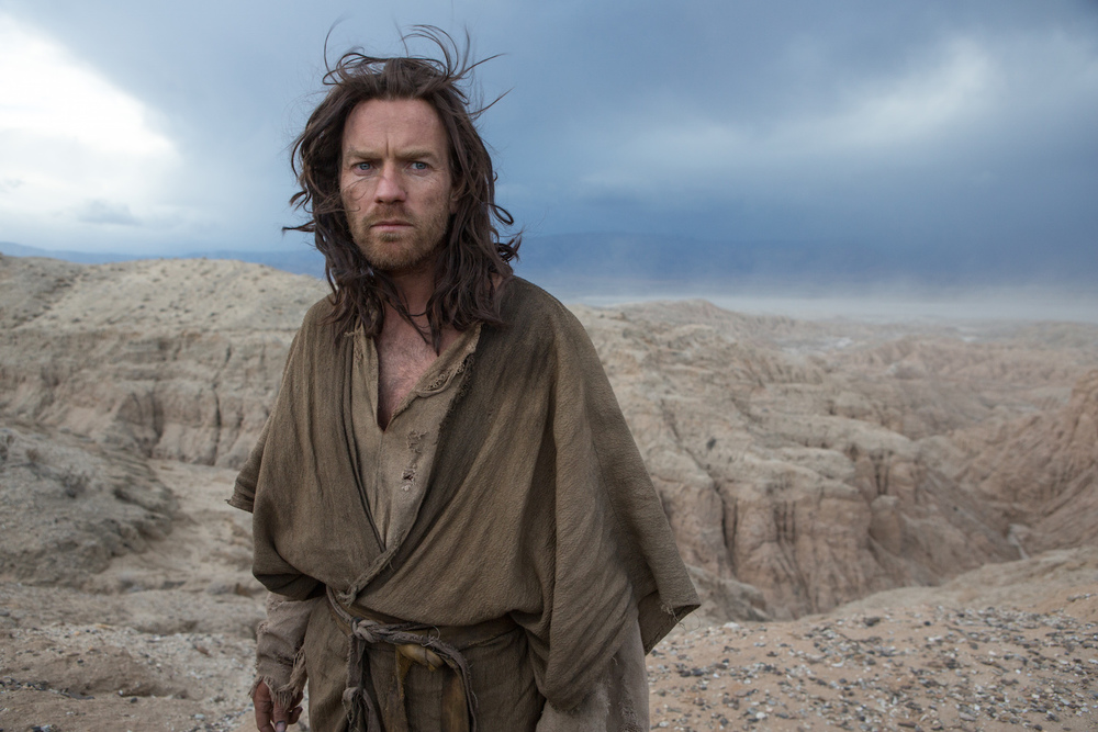 Ewan McGregor as Jesus in "Last Days in the Desert," standing in a barren landscape.
