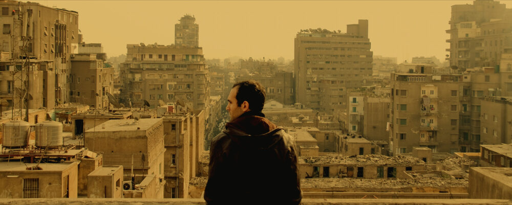 Man overlooking Cairo cityscape from "In the Last Days of the City