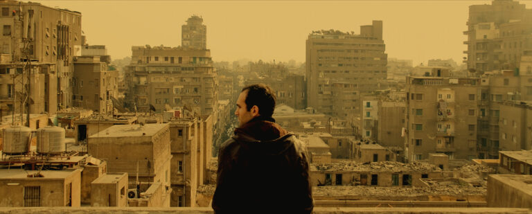 Man overlooking Cairo cityscape from "In the Last Days of the City
