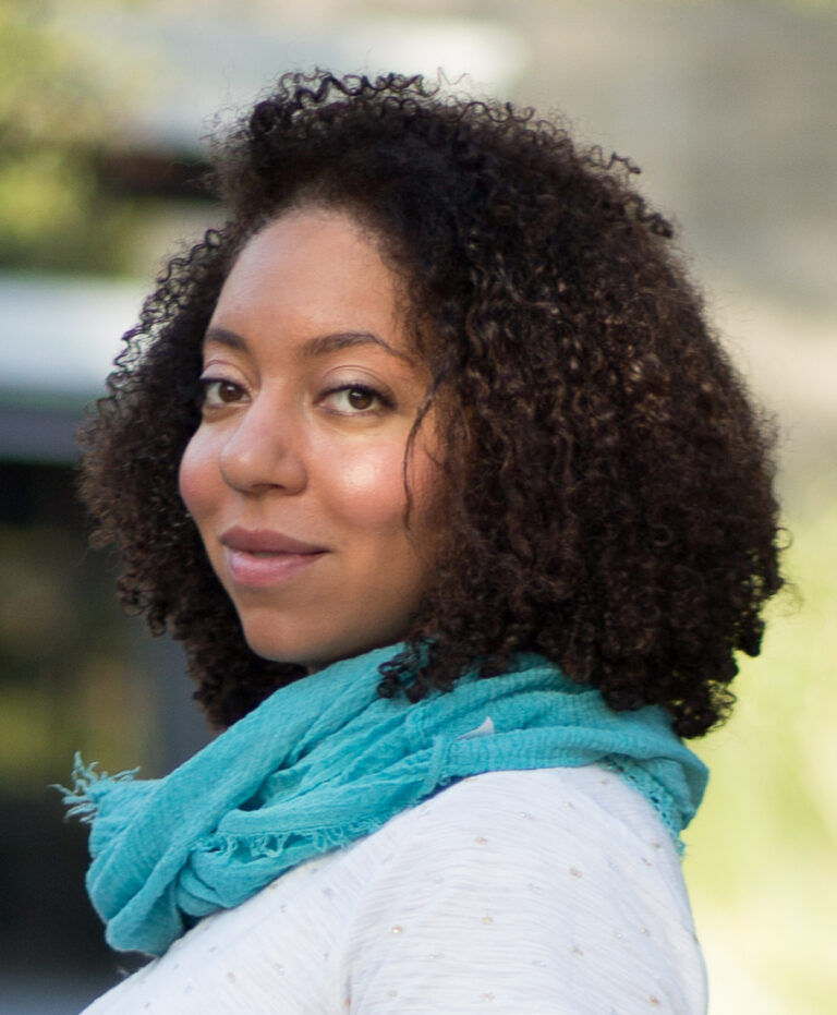 Lauren Waring Douglas, portrait of a woman with curly hair and a blue scarf.