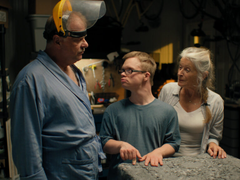 Family in "The Middle of the Garage," man with Down syndrome, parents nearby.