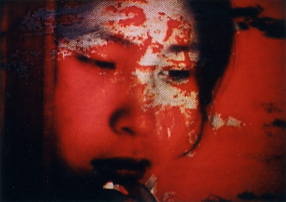 Distorted portrait of a face in red tones.