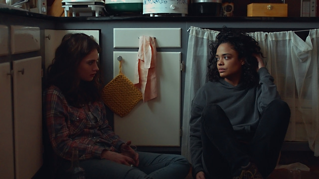 Tessa Thompson and Lily James in "Little Woods," sitting on a kitchen floor, looking concerned.