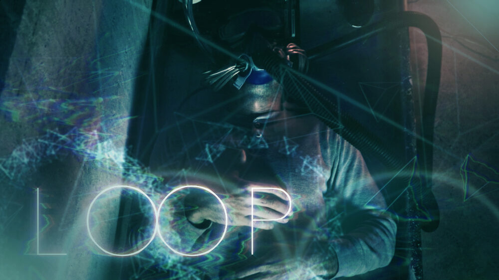 Man in a machine connected to wires, with "LOOP" text overlay. Sci-fi concept.