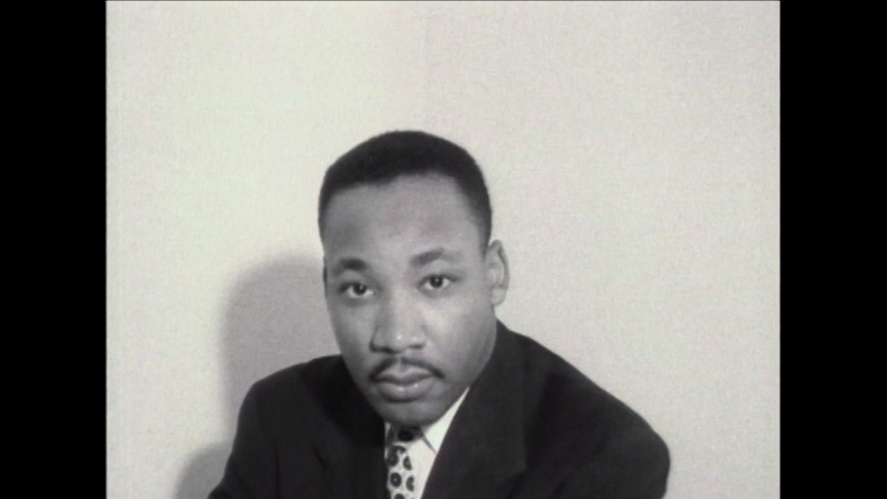Black and white portrait of Martin Luther King Jr. in a suit.