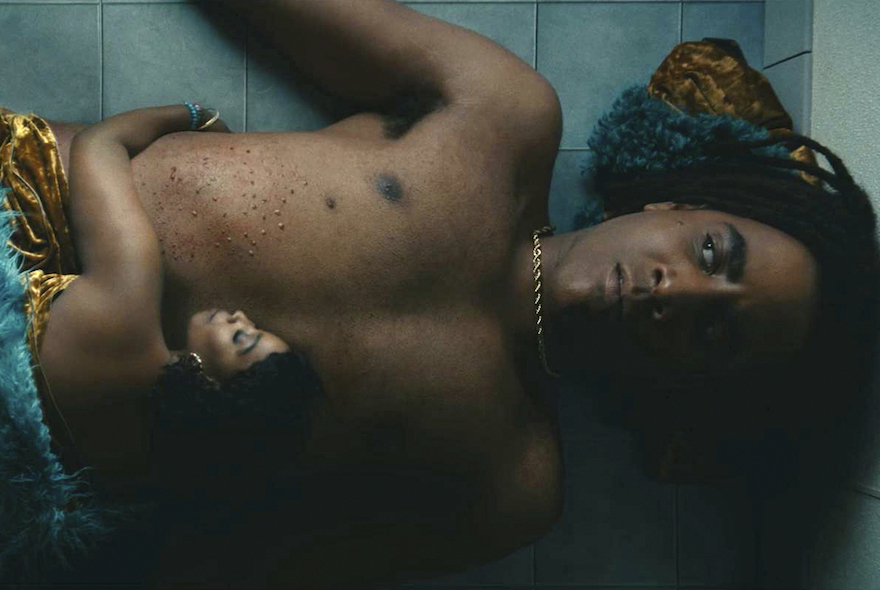 I'm a Virgo: Jharrel Jerome and Olivia Washington lie on a tiled floor, close together, wearing velvet and gold.
