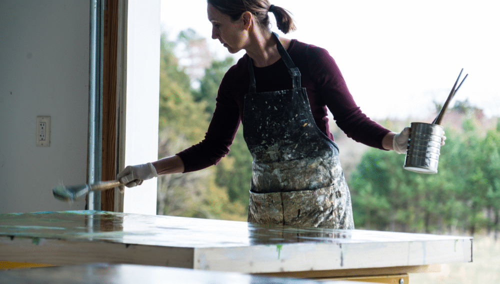 Artist Michelle Gagliano working on a painting in her studio.