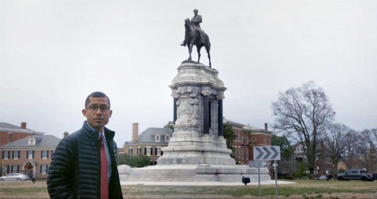 Man stands near the Robert E. Lee statue in Richmond, Virginia.
