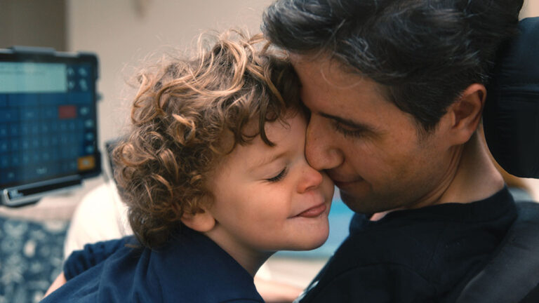 Father and son embrace, a tender moment of connection.