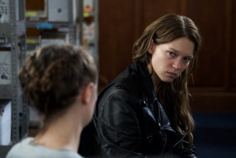 Léa Seydoux in "Oh Mercy!" looking intensely at another woman with her back to the camera.