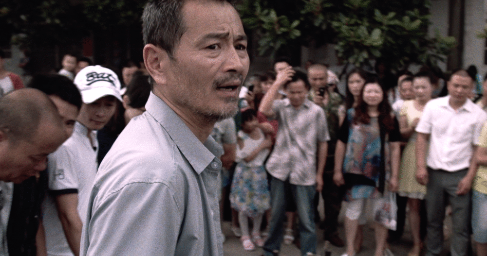 Concerned man in a crowd.