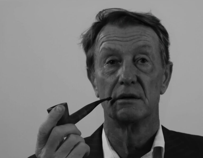 Black and white portrait of a man holding a pipe.