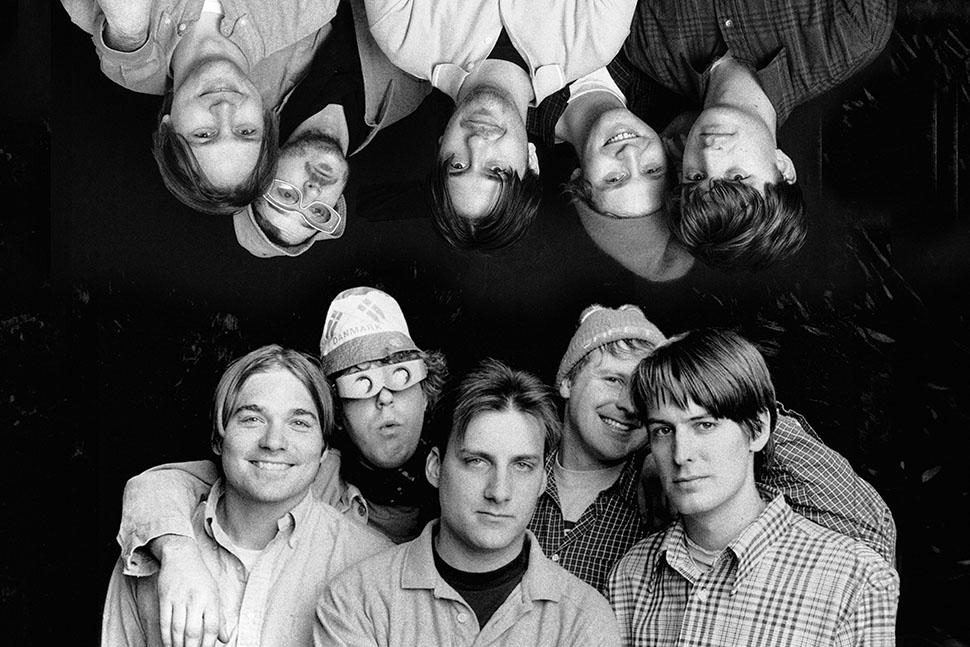 Pavement band portrait, black and white. Indie rock group shot with reflection effect.
