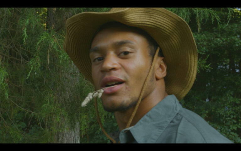 Man in cowboy hat with wheat in mouth, "But I Wanted to Be a Cowboy