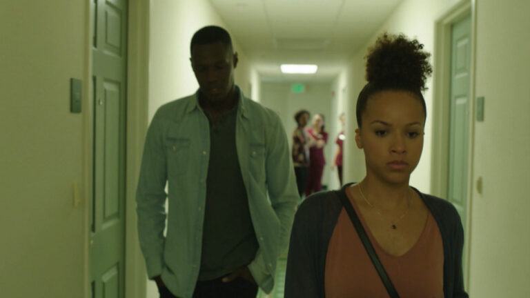 Couple walking down a hallway looking concerned