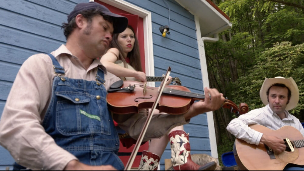 Bluegrass band playing fiddlin' music outdoors.