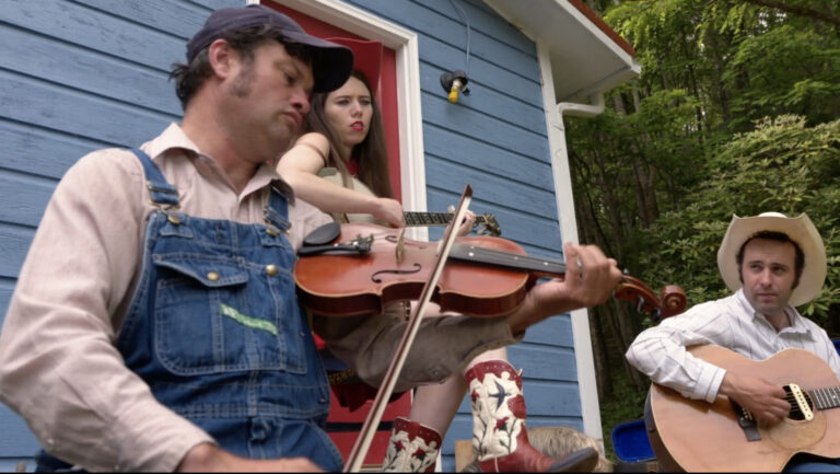 Bluegrass band playing fiddlin' music outdoors.