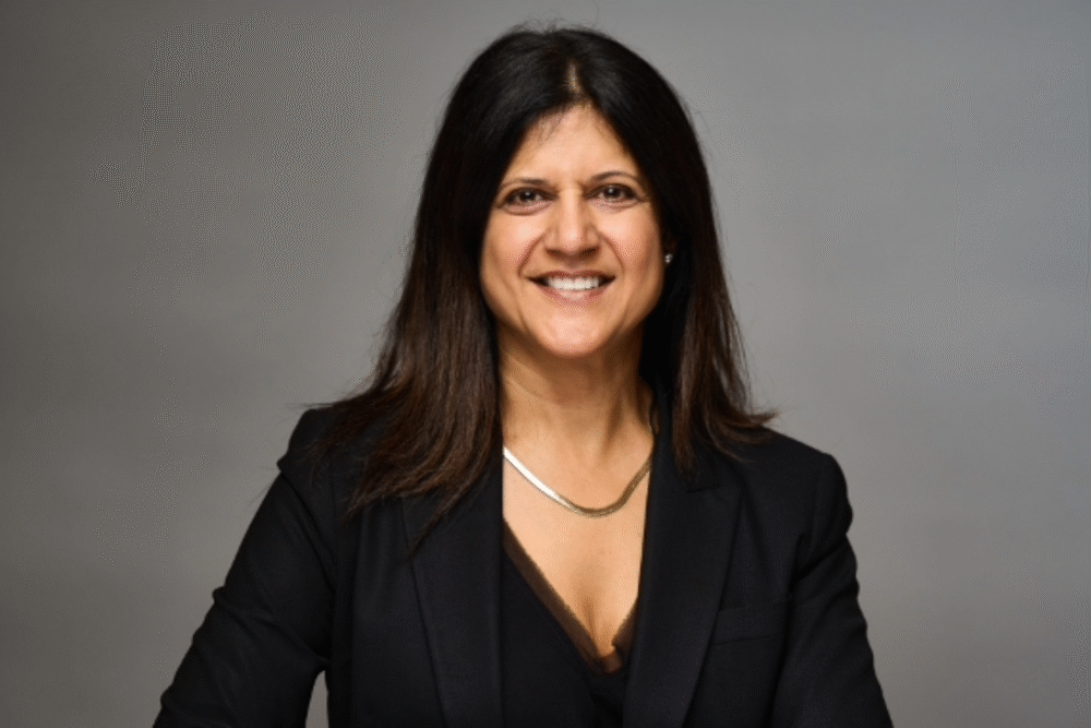 Irma Shrivastava, smiling in a professional headshot wearing a black blazer.