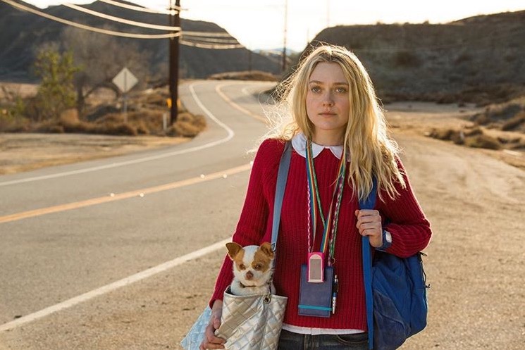 Dakota Fanning in "Please Stand By" movie, carrying a dog in a bag.