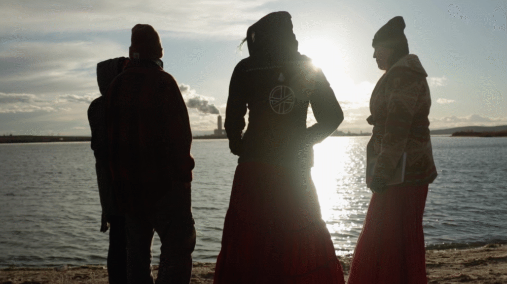 People silhouetted by water.