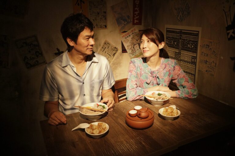 Couple enjoys ramen at a vintage-style ramen shop, sharing tea and a meal.