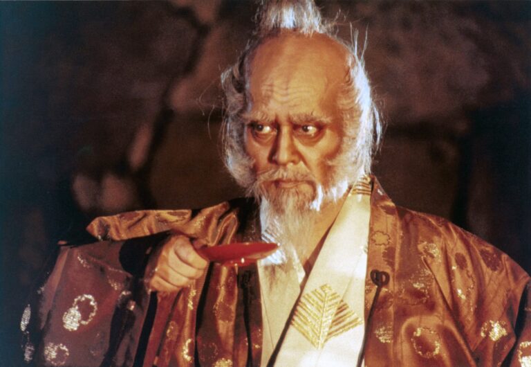 Lord Hidetora Ichimonji in Akira Kurosawa's Ran, holding a sake cup.