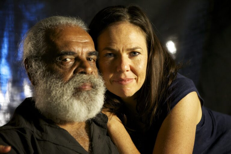 Man with white beard and woman embrace.