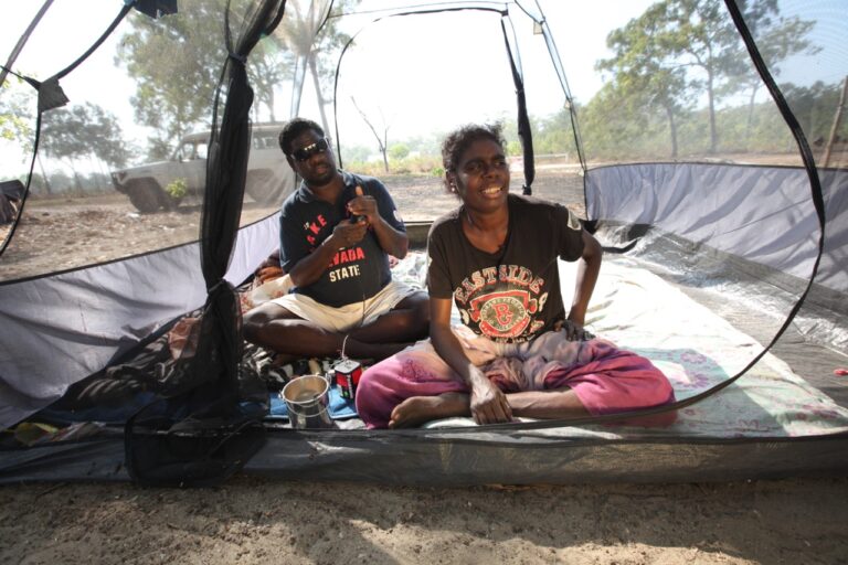 Couple in a tent, wearing "Westside State" shirts.