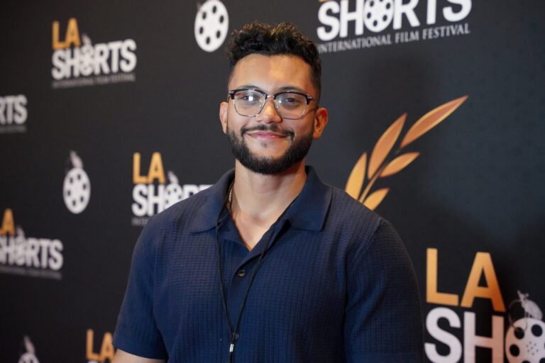 Roger Torres at the LA Shorts International Film Festival, wearing glasses and a navy polo shirt.