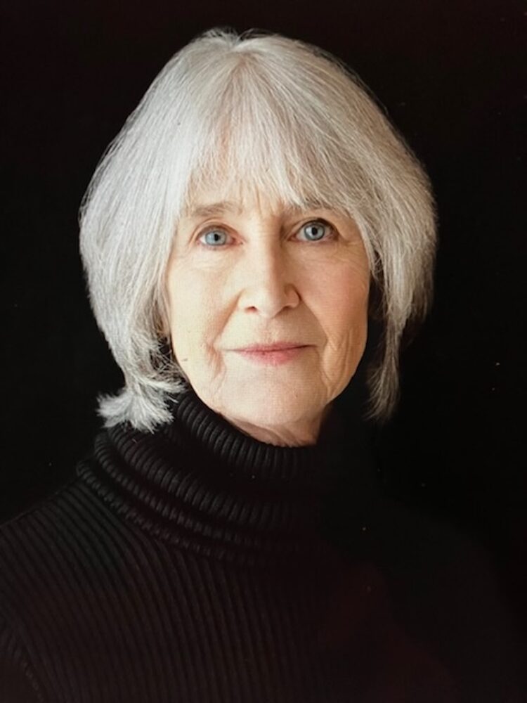 Portrait of author Roxana Robinson with striking blue eyes and silver hair.