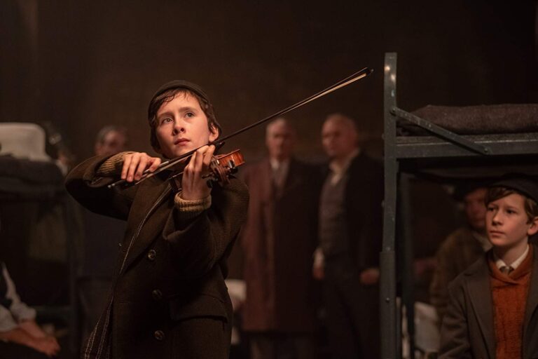 Young boy playing violin, scene from "The Song of Names