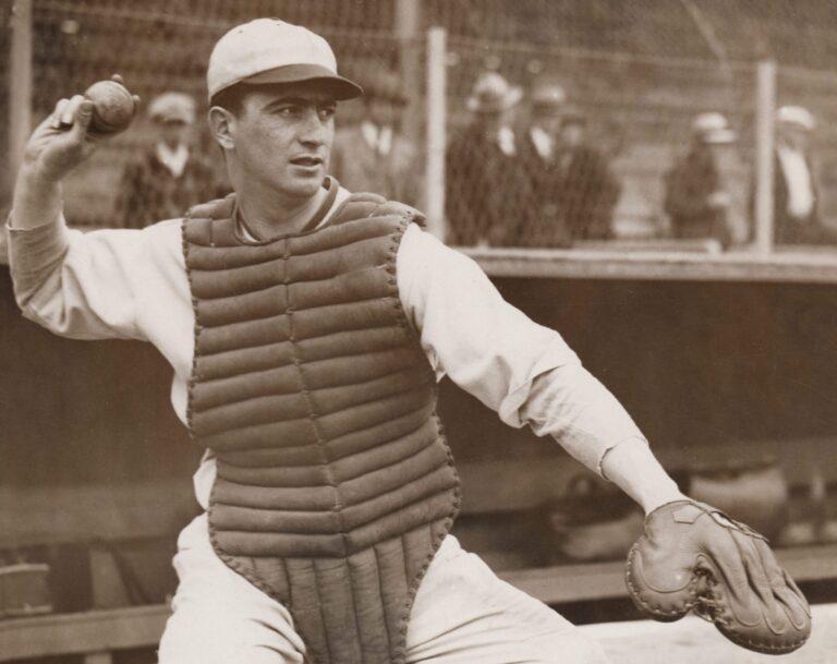 Moe Berg, "The Spy Behind Home Plate," in baseball catcher gear, throwing ball.