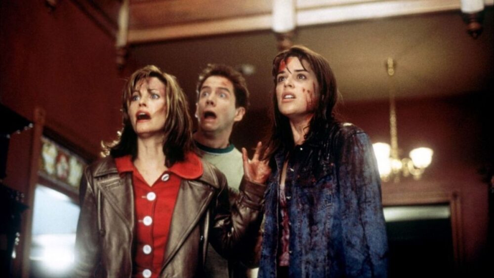 Scream movie scene with Neve Campbell looking shocked and covered in blood.