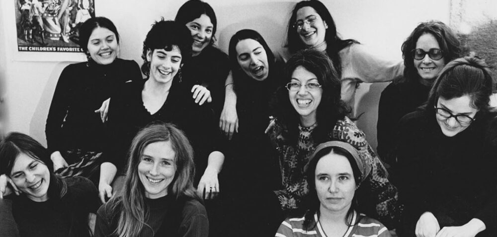 Group black and white portrait of women activists smiling.