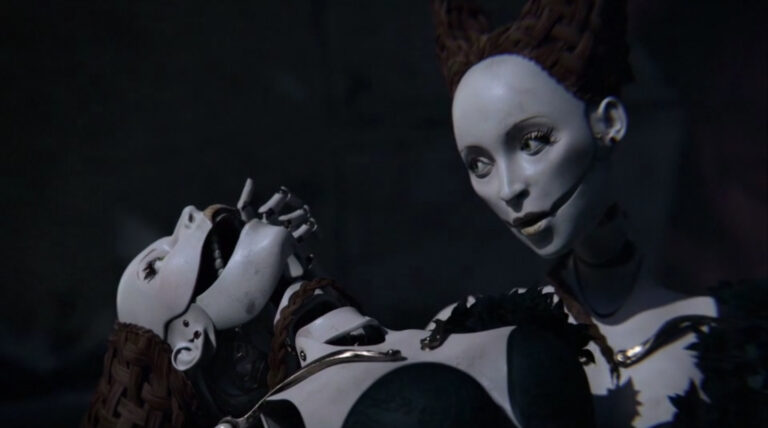 Creepy puppets in Block C short film, one holding the other's head open.