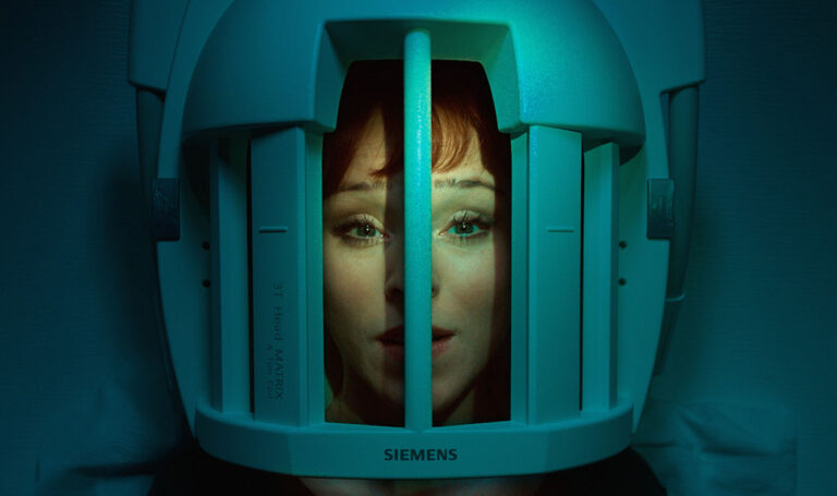 Woman's face inside a Siemens 3T Head Matrix MRI machine.